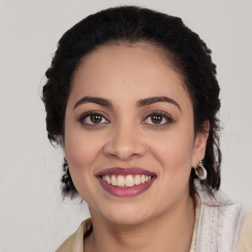 Joyful latino young-adult female with medium  black hair and brown eyes