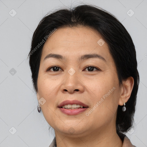 Joyful asian adult female with medium  brown hair and brown eyes