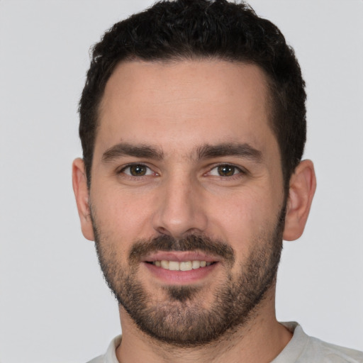 Joyful white young-adult male with short  brown hair and brown eyes