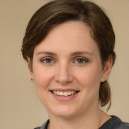 Joyful white young-adult female with medium  brown hair and grey eyes