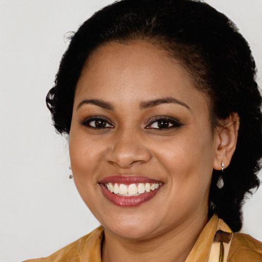 Joyful black young-adult female with long  brown hair and brown eyes