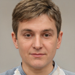 Joyful white adult male with short  brown hair and brown eyes