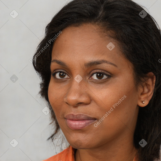 Joyful black young-adult female with long  brown hair and brown eyes