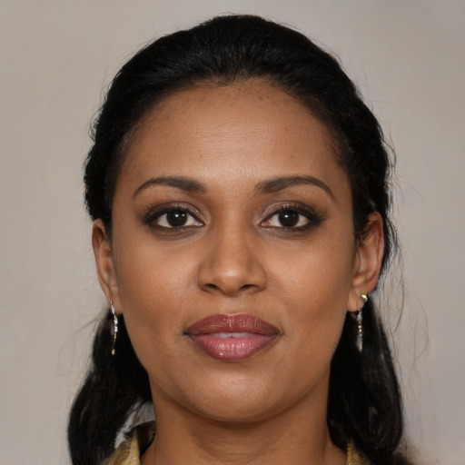 Joyful black young-adult female with medium  brown hair and brown eyes