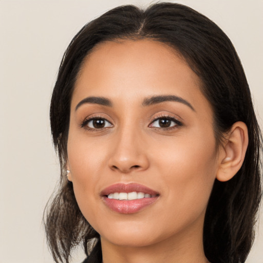 Joyful latino young-adult female with long  brown hair and brown eyes