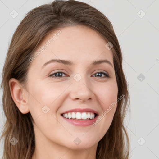 Joyful white young-adult female with long  brown hair and green eyes