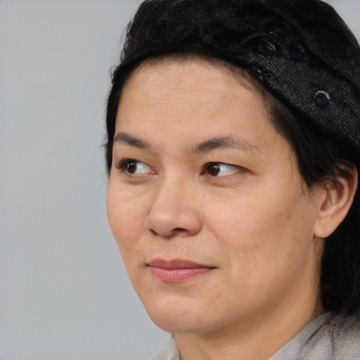 Joyful asian adult female with short  black hair and brown eyes