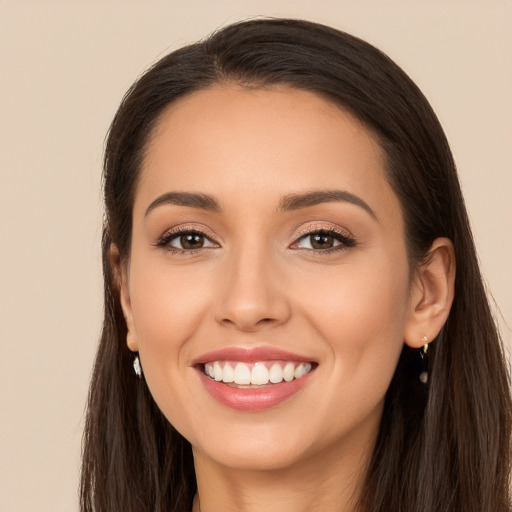 Joyful white young-adult female with long  brown hair and brown eyes