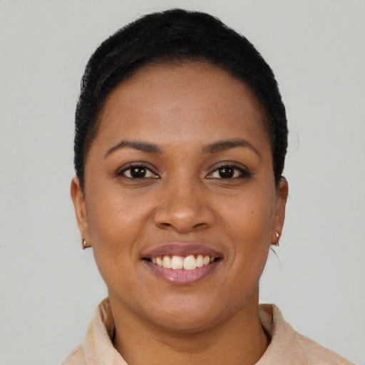 Joyful black young-adult female with short  brown hair and brown eyes