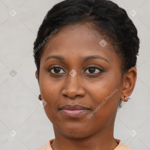 Joyful black young-adult female with short  brown hair and brown eyes