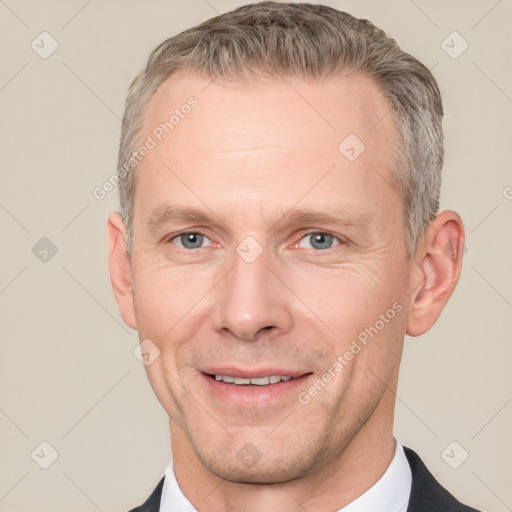 Joyful white adult male with short  brown hair and grey eyes