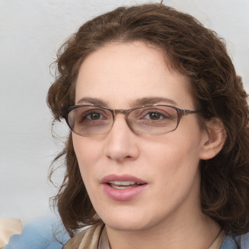 Joyful white adult female with medium  brown hair and blue eyes