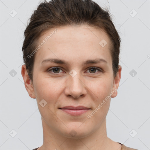 Joyful white young-adult female with short  brown hair and grey eyes