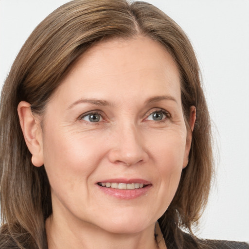 Joyful white adult female with medium  brown hair and grey eyes