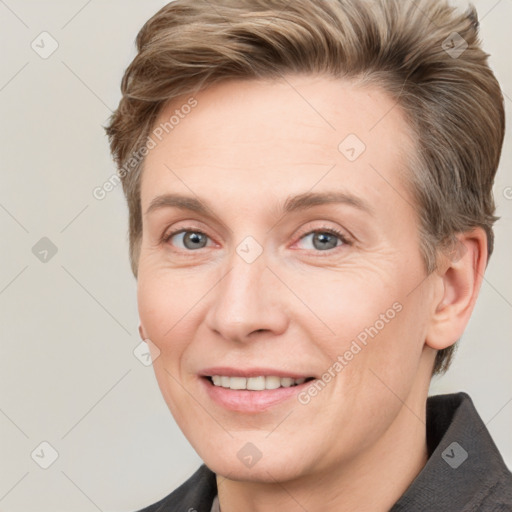 Joyful white adult female with short  brown hair and grey eyes