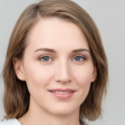 Joyful white young-adult female with medium  brown hair and blue eyes