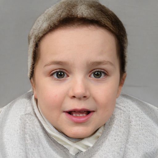 Joyful white child female with short  brown hair and blue eyes