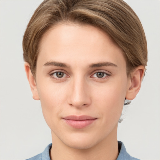 Joyful white young-adult female with short  brown hair and grey eyes