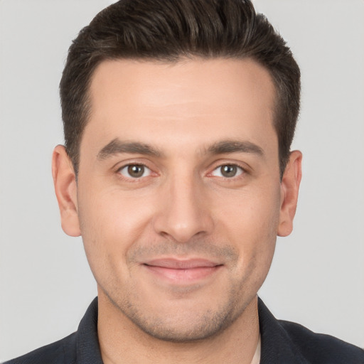 Joyful white young-adult male with short  brown hair and brown eyes