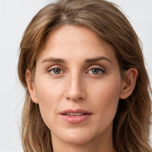 Joyful white young-adult female with long  brown hair and green eyes