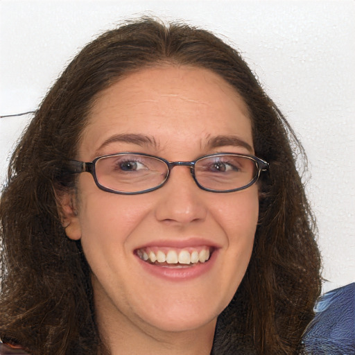 Joyful white adult female with long  brown hair and brown eyes