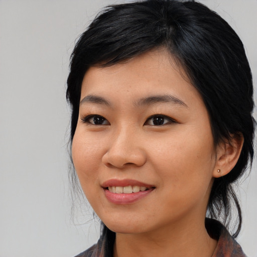 Joyful asian young-adult female with medium  black hair and brown eyes