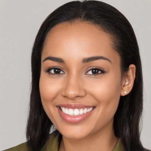 Joyful latino young-adult female with long  brown hair and brown eyes