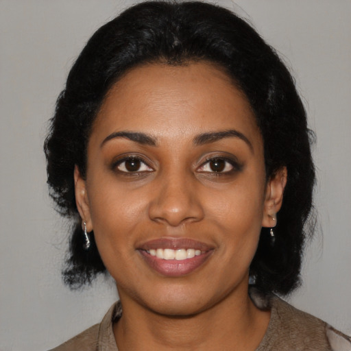 Joyful black young-adult female with medium  black hair and brown eyes