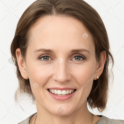 Joyful white young-adult female with medium  brown hair and grey eyes