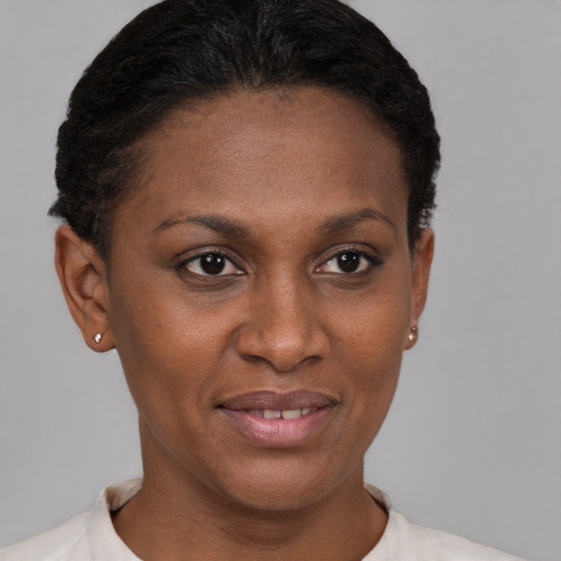Joyful black young-adult female with short  brown hair and brown eyes