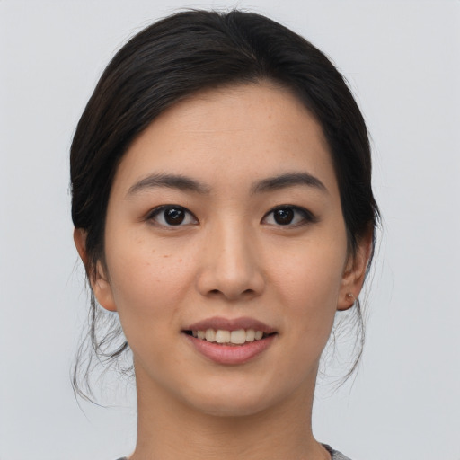 Joyful asian young-adult female with medium  black hair and brown eyes