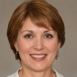 Joyful white adult female with medium  brown hair and brown eyes