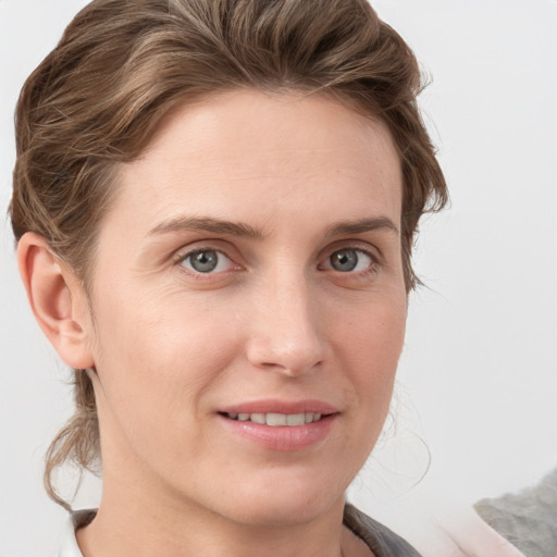 Joyful white young-adult female with medium  brown hair and blue eyes