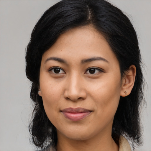 Joyful asian young-adult female with medium  brown hair and brown eyes