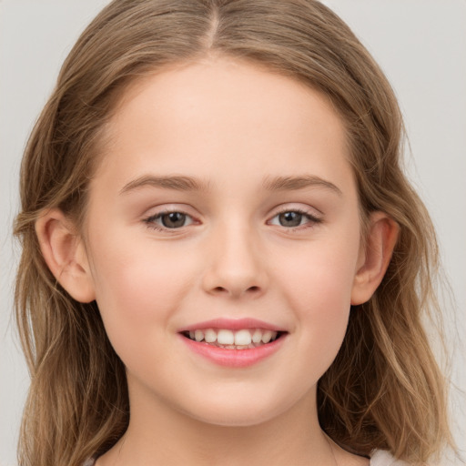 Joyful white child female with long  brown hair and grey eyes