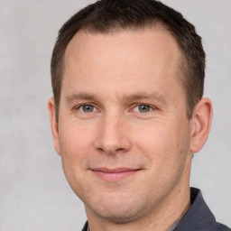 Joyful white adult male with short  brown hair and brown eyes