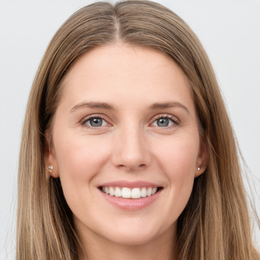 Joyful white young-adult female with long  brown hair and grey eyes