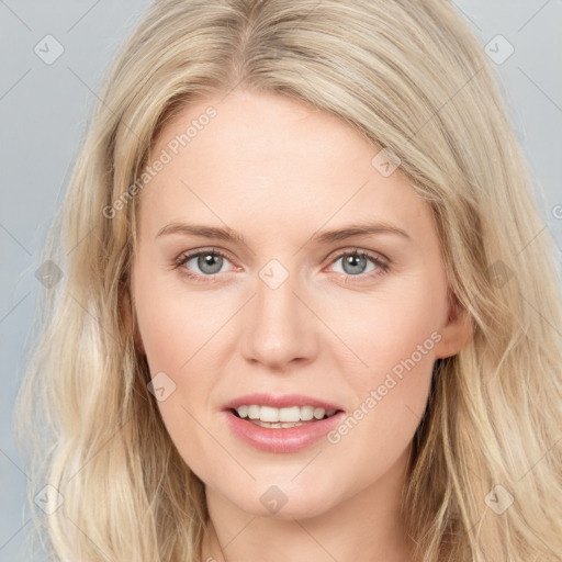 Joyful white young-adult female with long  brown hair and blue eyes