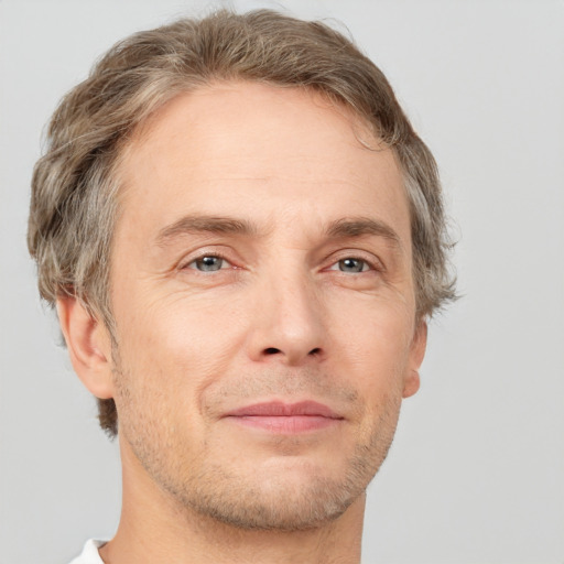 Joyful white adult male with short  brown hair and grey eyes