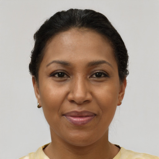 Joyful latino adult female with short  brown hair and brown eyes