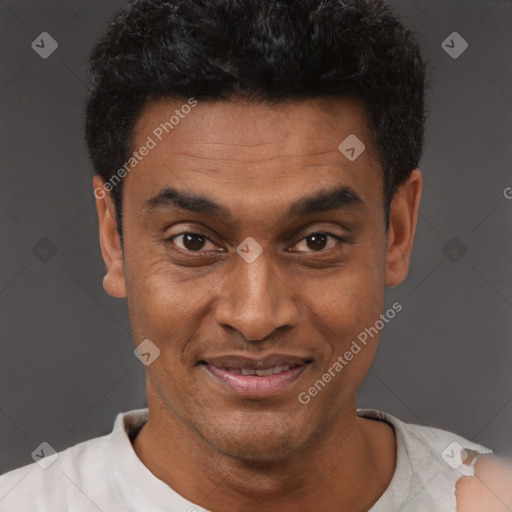 Joyful latino adult male with short  black hair and brown eyes