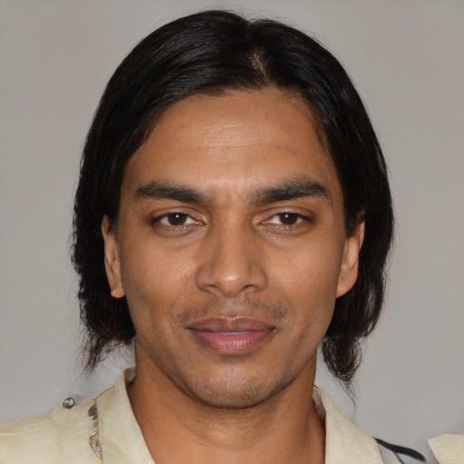 Joyful black young-adult male with medium  black hair and brown eyes