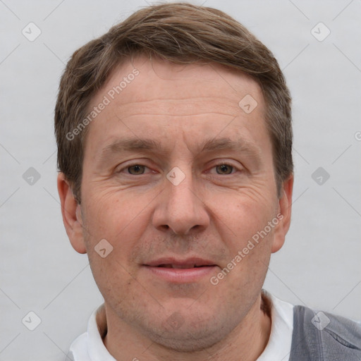 Joyful white adult male with short  brown hair and grey eyes