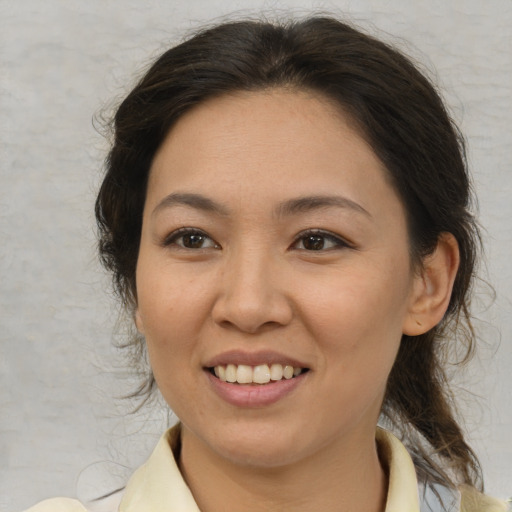 Joyful latino young-adult female with medium  brown hair and brown eyes