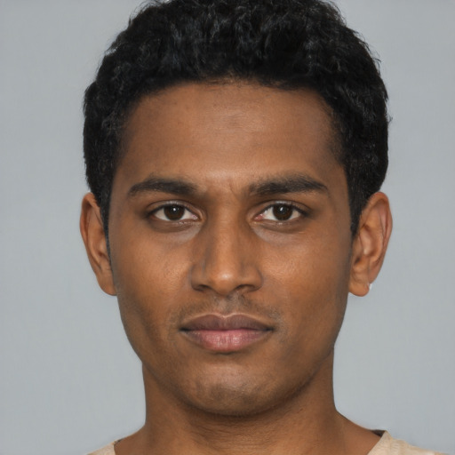 Neutral black young-adult male with short  black hair and brown eyes
