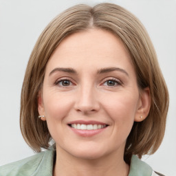 Joyful white young-adult female with medium  brown hair and green eyes