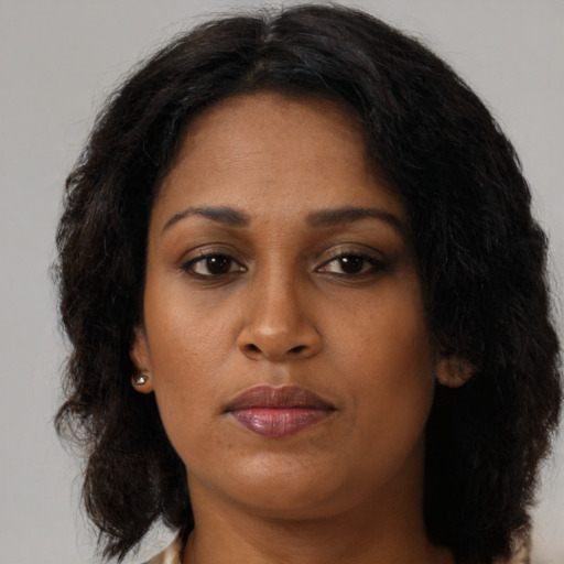 Neutral black young-adult female with long  brown hair and brown eyes