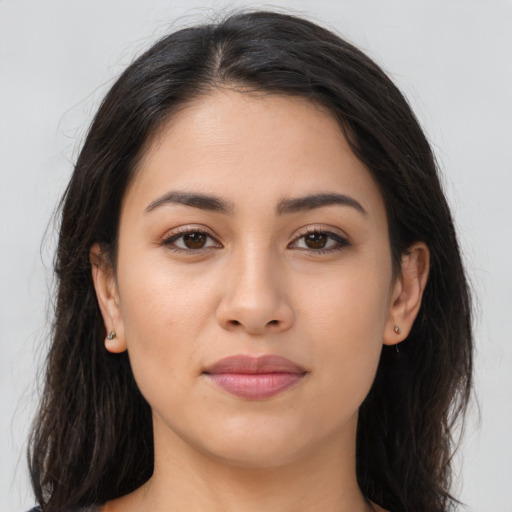 Joyful latino young-adult female with long  brown hair and brown eyes