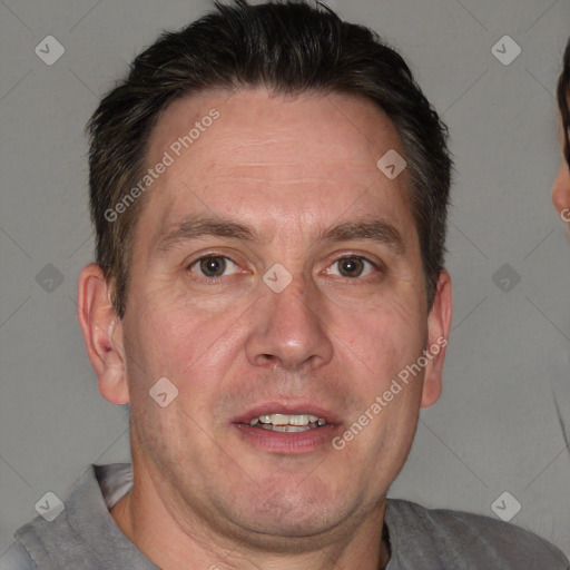 Joyful white adult male with short  brown hair and grey eyes