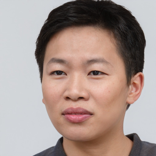 Joyful asian young-adult male with short  brown hair and brown eyes